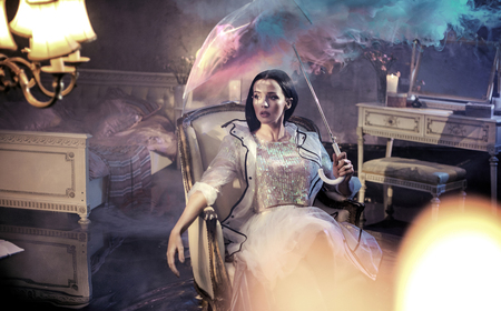 elegant, young woman in the rainy, luxurious apartmentの写真素材