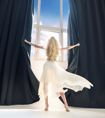 Attractive blond lady exposing a huge windowの写真素材