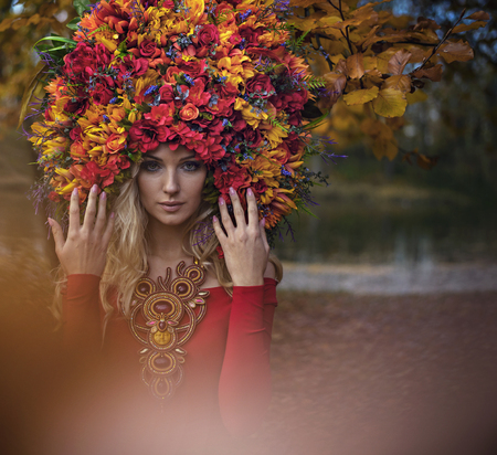 Beautiful blond nymph wearing an impressive, colorful coronetの写真素材
