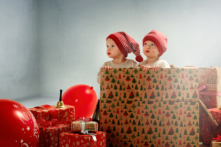 Portrait of joyful twin-elves among huge Christmas presentsの写真素材