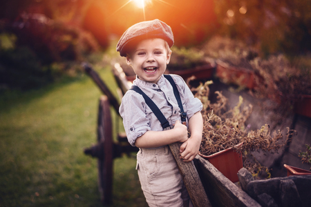 Cute, little gentleman relaxing a spare time on a farmの写真素材