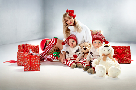 Charming, young mother posing with her twin sonsの写真素材