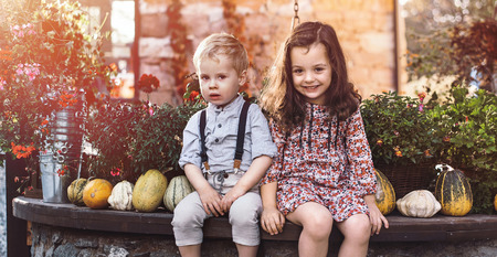 Portrait of little siblings on an autumnal farmの写真素材