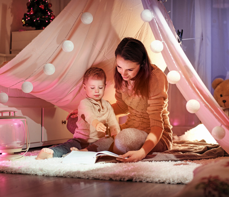 Young mother speding time with her beloved, cute sonの写真素材