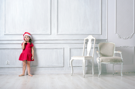 Portrait of a little, cute girl wearing a santa hatの写真素材