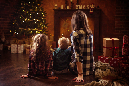Portrait of a cheerful family realxing in a winter, calm eveningの写真素材