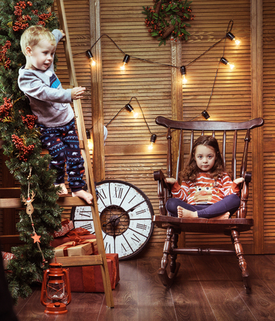 Cheerful, little kids in a stylish interiorの写真素材