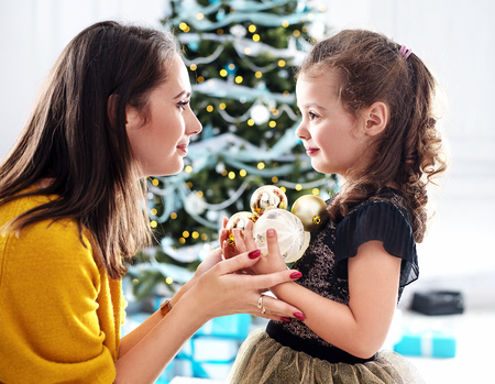 Mother and daughter holding colorful glass ballsの写真素材