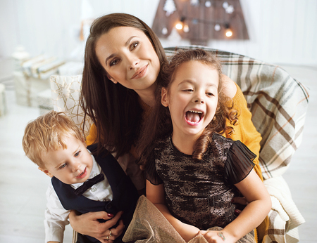 Elegant mother posing with her beloved childrenの写真素材