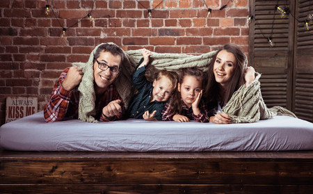 Portrait of a cheerrful family relaxing in a stylish, modern interiorの写真素材