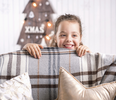 Portrait of a cute, little girl in a modern interiorの写真素材