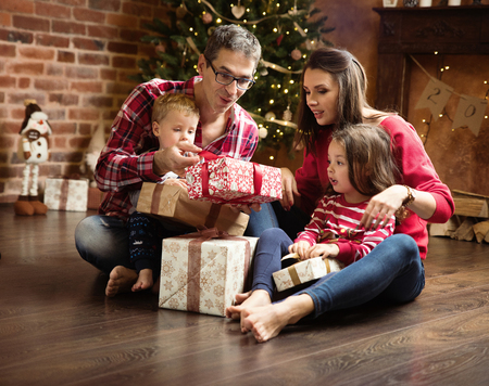 Cheerful, realxed family unboxing presents togetherの写真素材