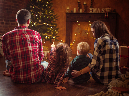 Portrait of a cheerful family realxing in a winter, calm eveningの写真素材