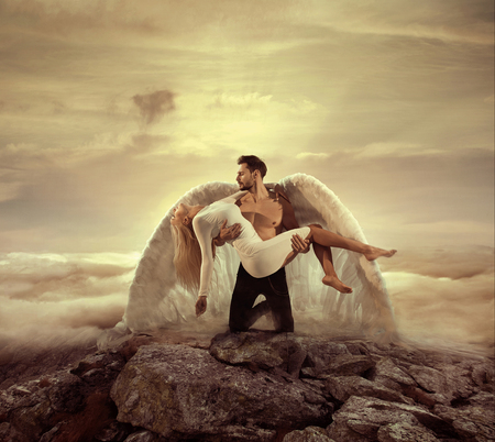 Portrait of an archangel carrying a beautiful innocent ladyの写真素材