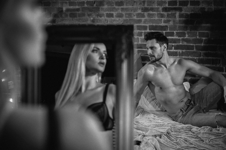 Sensual, young couple relaxing in a modern, stylish apartmentの写真素材