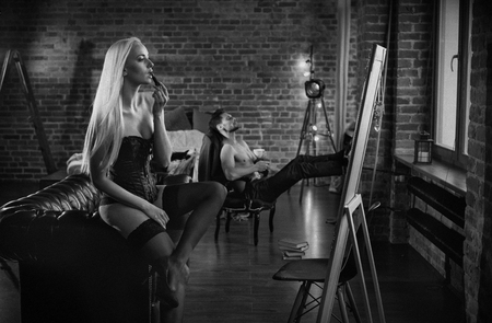 Sensual, young couple relaxing in a modern, stylish apartmentの写真素材