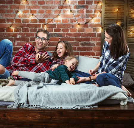 Portrait of a cheerrful family relaxing in a stylish, modern interiorの写真素材