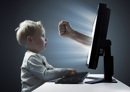 Cute, little boy looking at the display  monitor - Internet violence symbolの写真素材