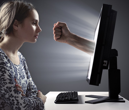Pretty woman looking at the monitor - Internet violence symbolの写真素材