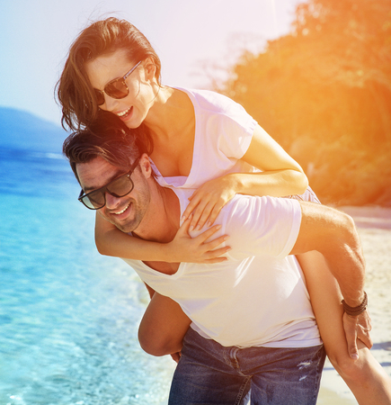 Young, attractive couple relaxing on a hot, tropical beachの写真素材