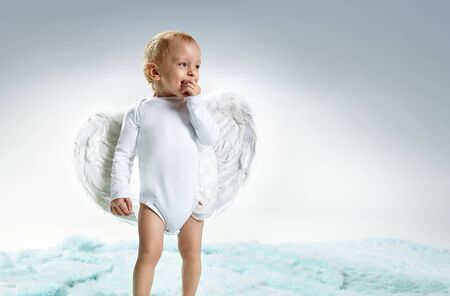 Closeup portrait of a cute, little angel - boyの写真素材