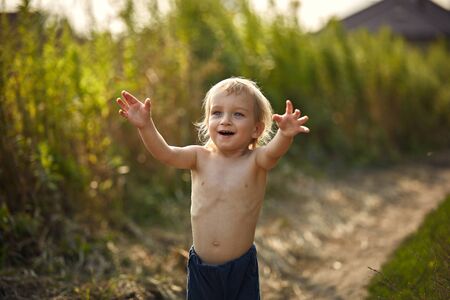 Portrait of a little, blond boy in the countrysideの写真素材