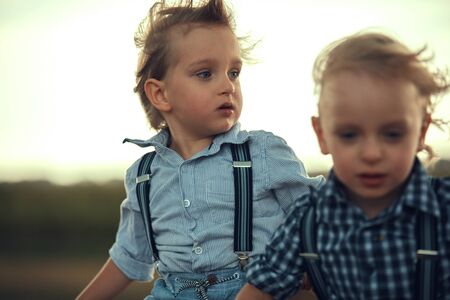 Two adorable brothers having fun in the countrysideの写真素材