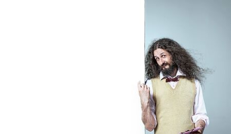 Eccentric man pointng on the white boardの写真素材