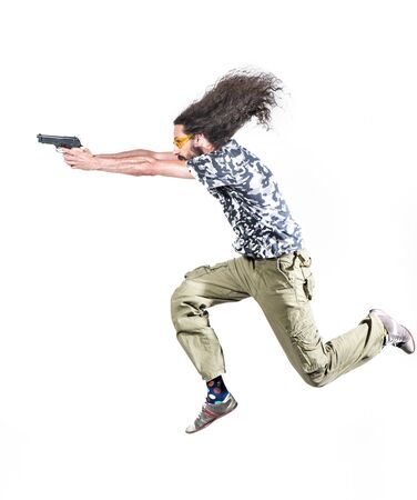 Portrait of a skinny guy poiting a gun - isolatedの写真素材
