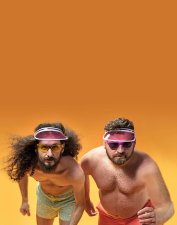 Funny portrait of two weird, antagonist friends on vacationの写真素材