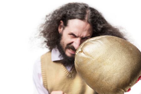 Portrait of a skinny geek punching with a boxing glove
