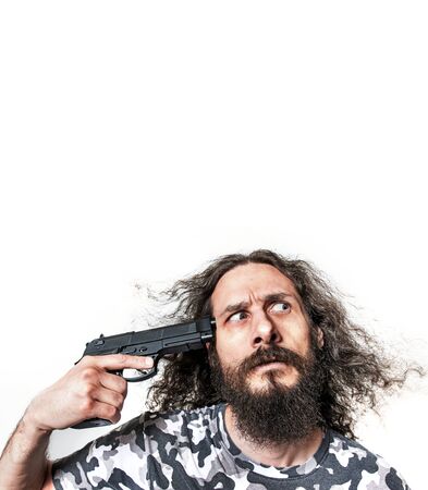 Portrait of a skinny guy poiting a gun - isolatedの写真素材