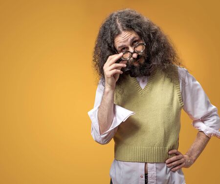 Portrait of a funny nerd holding the weird eyeglassesの写真素材