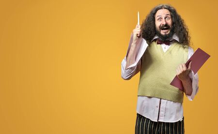 Portrait of a skinny, funny nerd holding a pen and notepad - idea conceptの写真素材