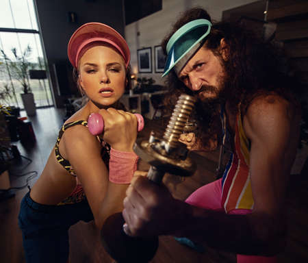 A funny couple doing exercises at home