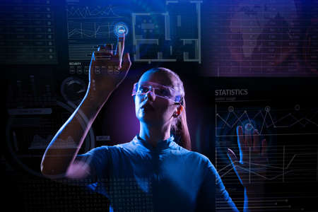 Concept of future technology or entertainment system, virtual reality. Female portrait lit by HUD...