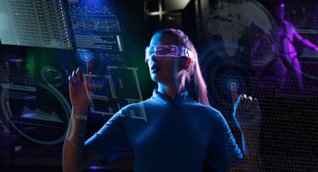 Concept of future technology or entertainment system, virtual reality. Female portrait lit by HUD interfaceの写真素材