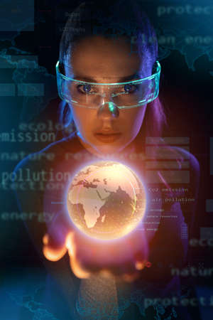 Concept of future technology or entertainment system, virtual reality. Female portrait lit by HUD interfaceの写真素材