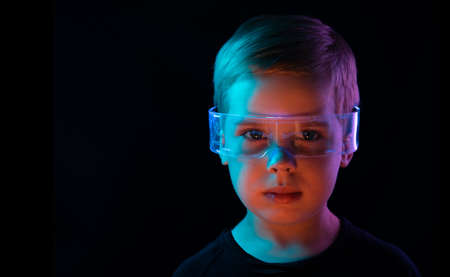 Cute little boy using digital glasses. sci-fi, earth awareness, future mind controlling conceptの写真素材