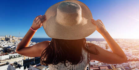 Happy young woman with straw hat enjoying her summer holidaysの写真素材
