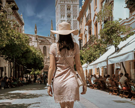 Happy young woman with straw hat enjoying her summer holidaysの写真素材