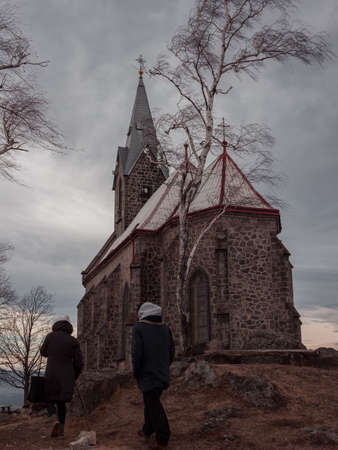 Church at the mountain top surrounded by trees with cloudy sky in the background. Church of Our Lady of Sorrows built in 1878 - 1880 Czech Republic, Å½ulovÃ¡の写真素材