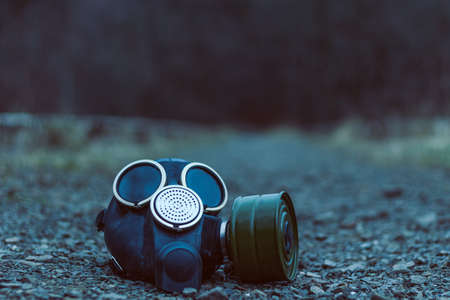 Closeup of the old gas mask lying at the groundの写真素材