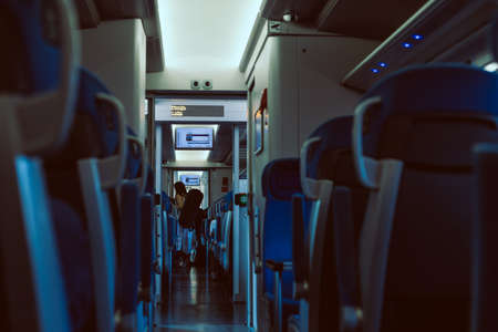 interior of the train wagon with passenger in the background