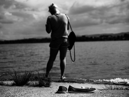 women's espadrilles on the lakeside with the silhouette of a girl in the background