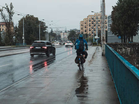 cycling in the rain, streets of the cityの写真素材