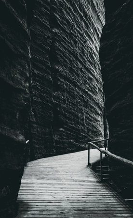 wooden mountain trail between rocks