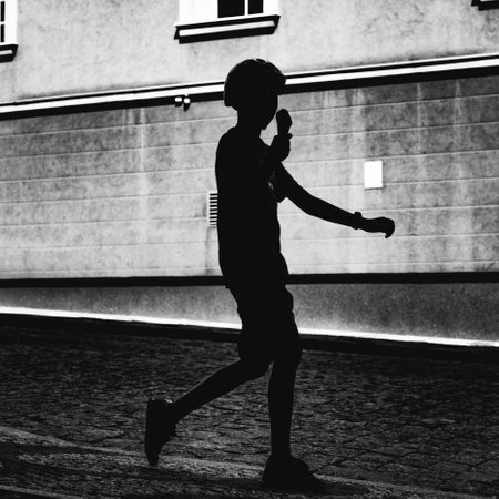 silhouette of kid eating ice creamの写真素材