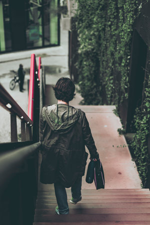 woman on the exterior stairs of a building