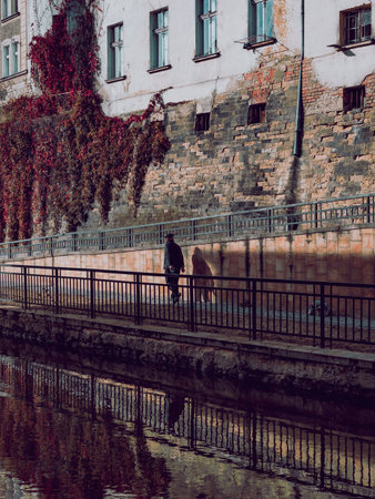silhouette of the man at the city river boulevardの写真素材
